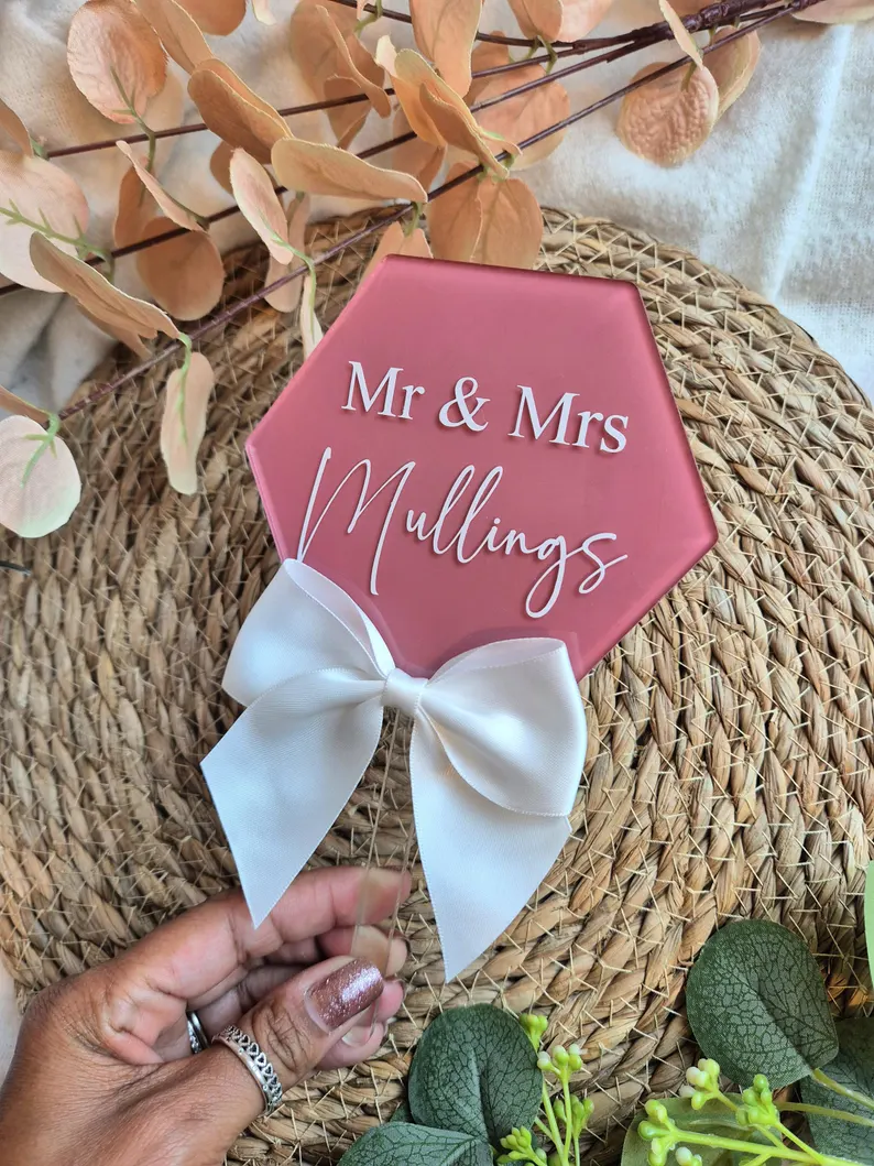 Personalised pink hexagon Mr and Mrs surname wedding cake topper with white bow