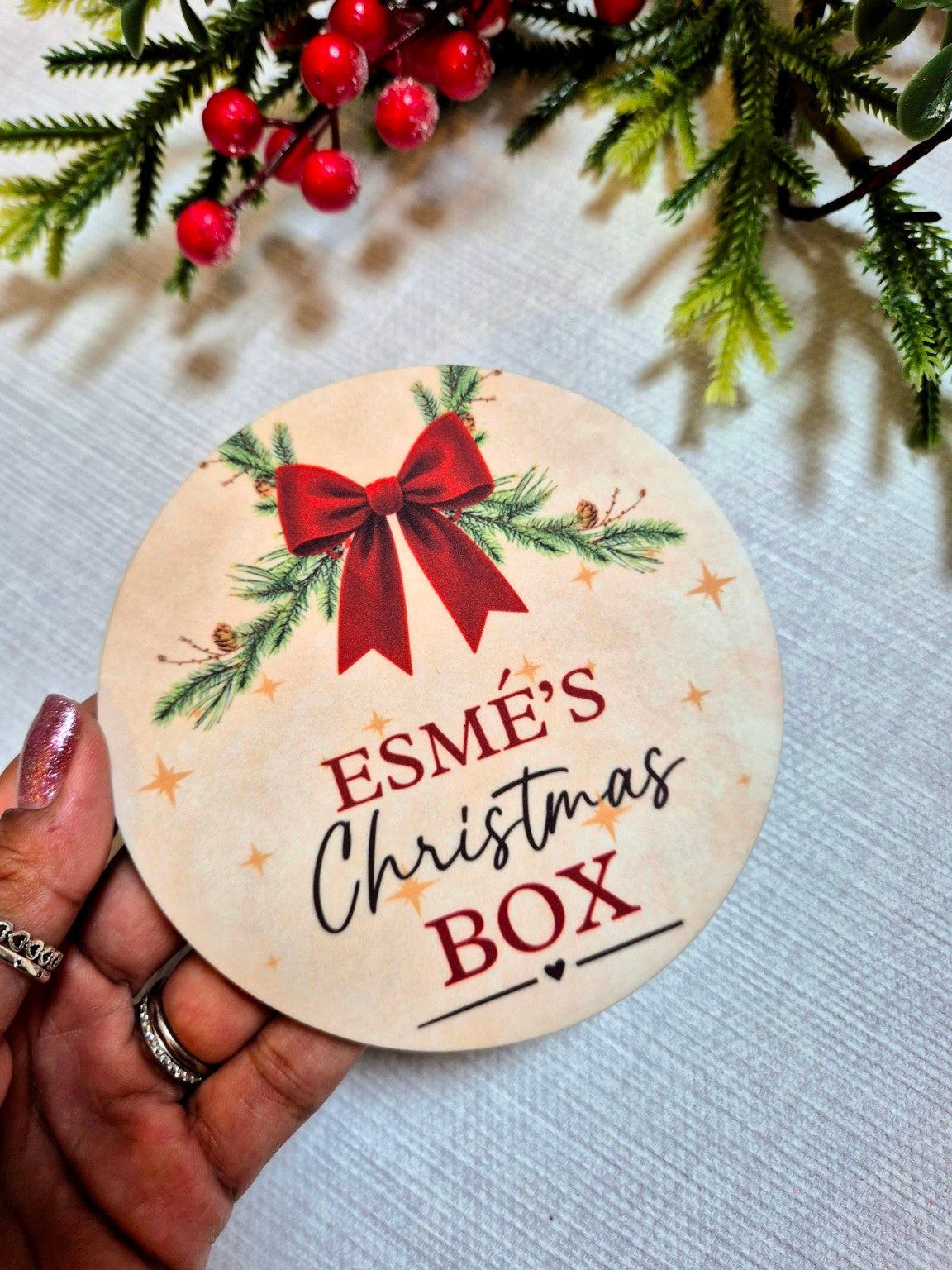 Red Bow personalised Christmas Box disc held in hand