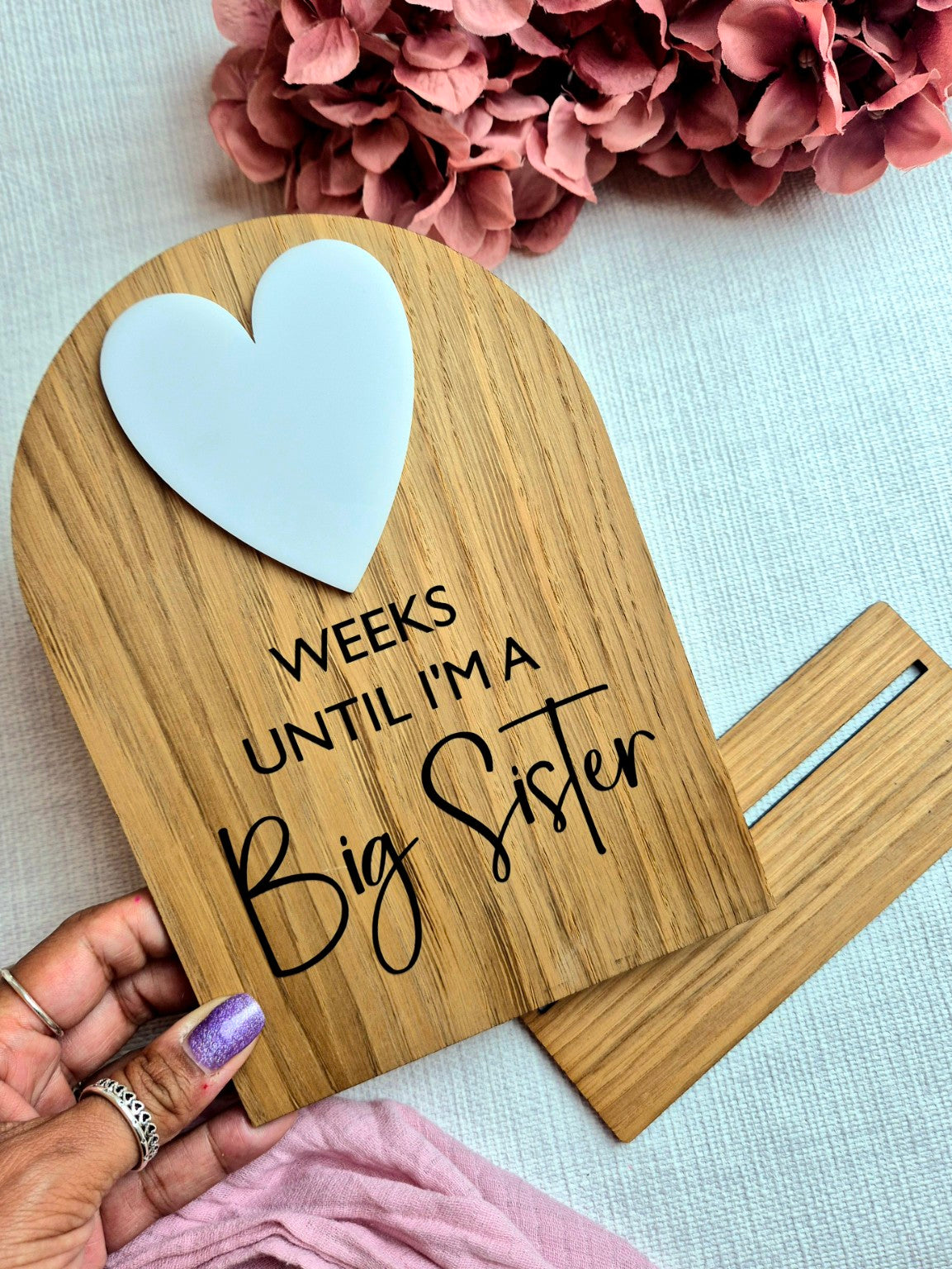 Big Sister pregnancy countdown plaque held in hand