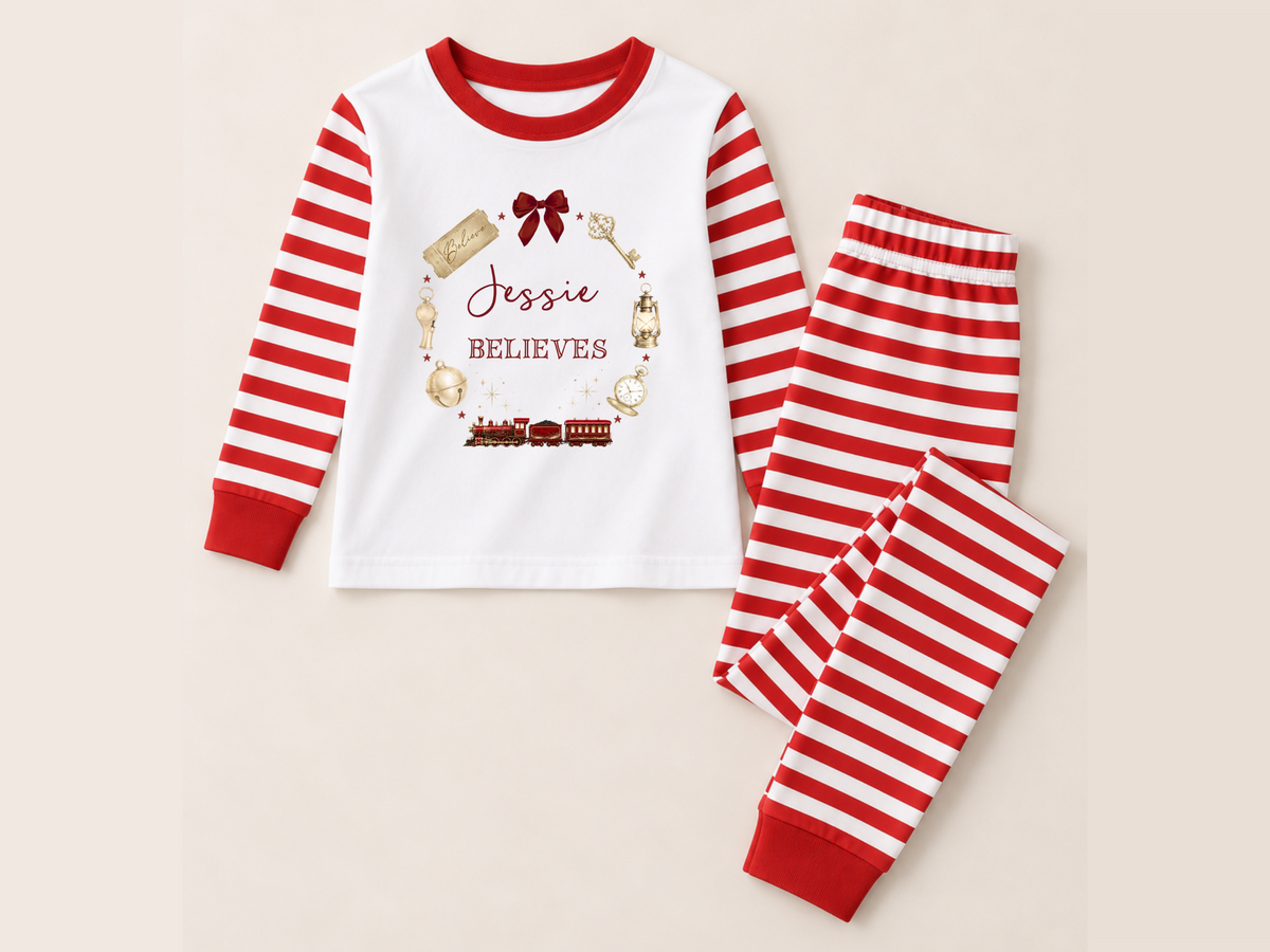 Preview of the Christmas Believes design on red striped pyjamas; child-sized garment pictured to illustrate the artwork, adult cut differs